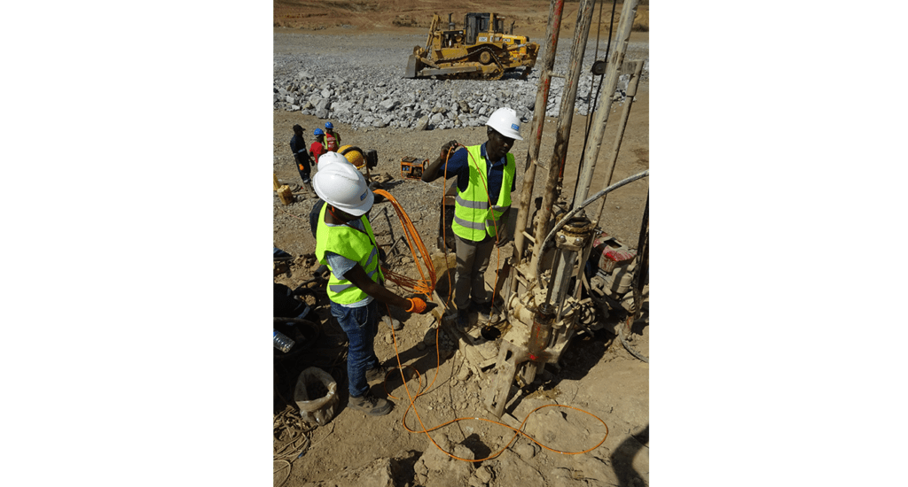 Drilling team installing vibrating a wire piezometer VWP-3000 at Kabaale airport