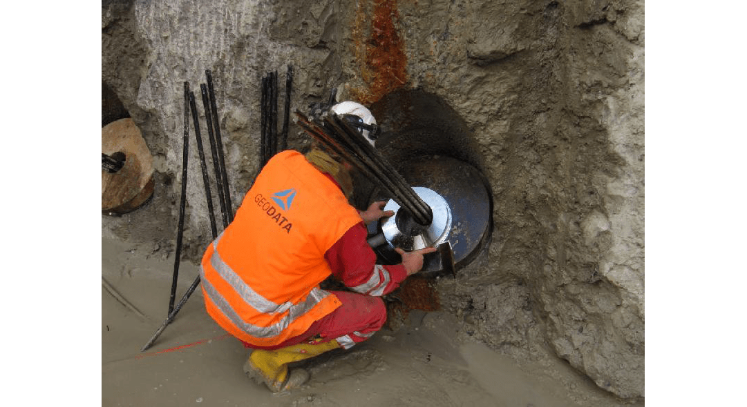 Engineer fitting load distribution plate for load cell during Nordhaven metro station construction